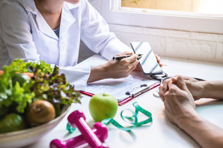 Picture of a medical professional showing their cell phone to a patient.