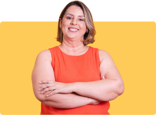 Picture showing person in orange shirt smiling with arms crossed