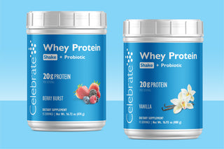 Two white plastic tubs of Celebrate Whey Protein Shake + Probiotic dietary supplements on a light blue gradient background. The left tub is Berry Burst flavor with berry illustrations, and the right tub is Vanilla flavor with vanilla orchid illustrations.