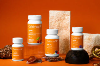 Celebrate vitamin supplement bottles on an orange background