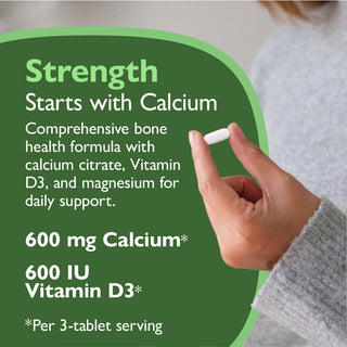 Hand holding a supplement with text about calcium and vitamin D3 on a green background