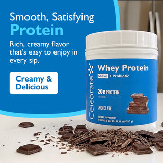 Celebrate Whey Protein container with chocolate pieces on a white surface